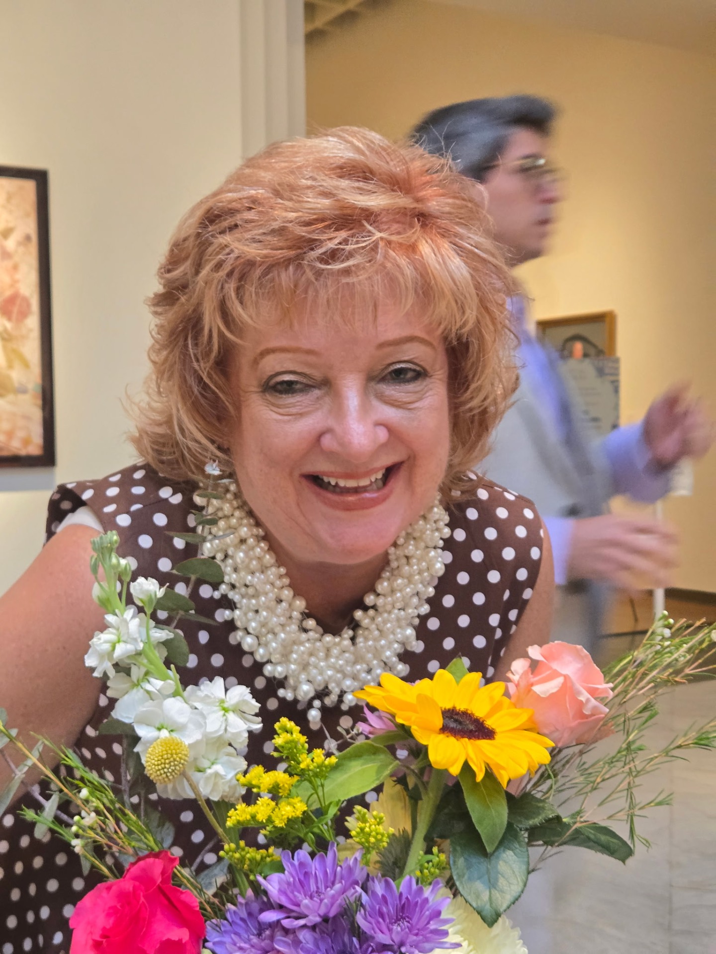 Tina Leger, owner of Settled In by Tina, holding flowers