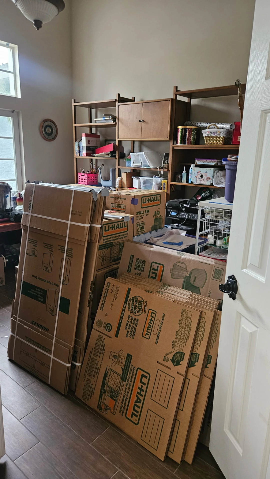 Flat moving boxes and packing supplies prepared in a craft room