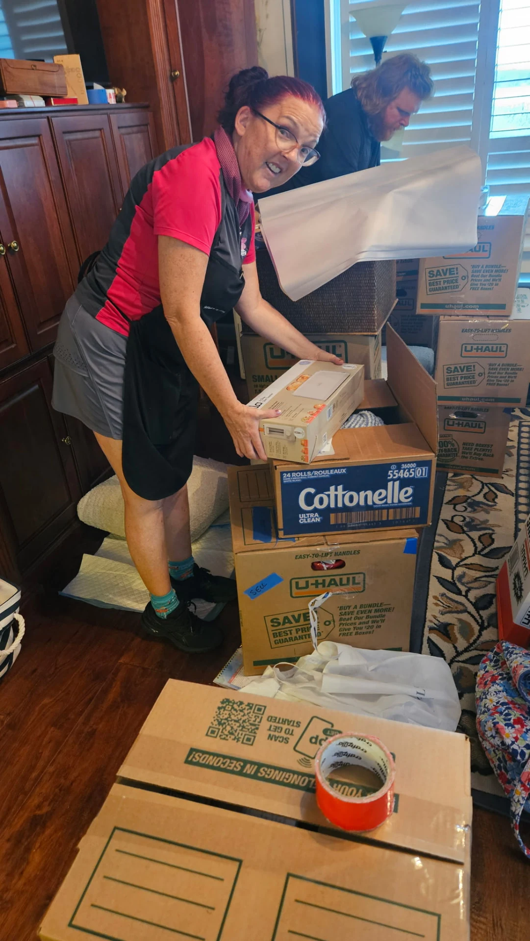 Tina and Jackson packing boxes together in a client's bedroom